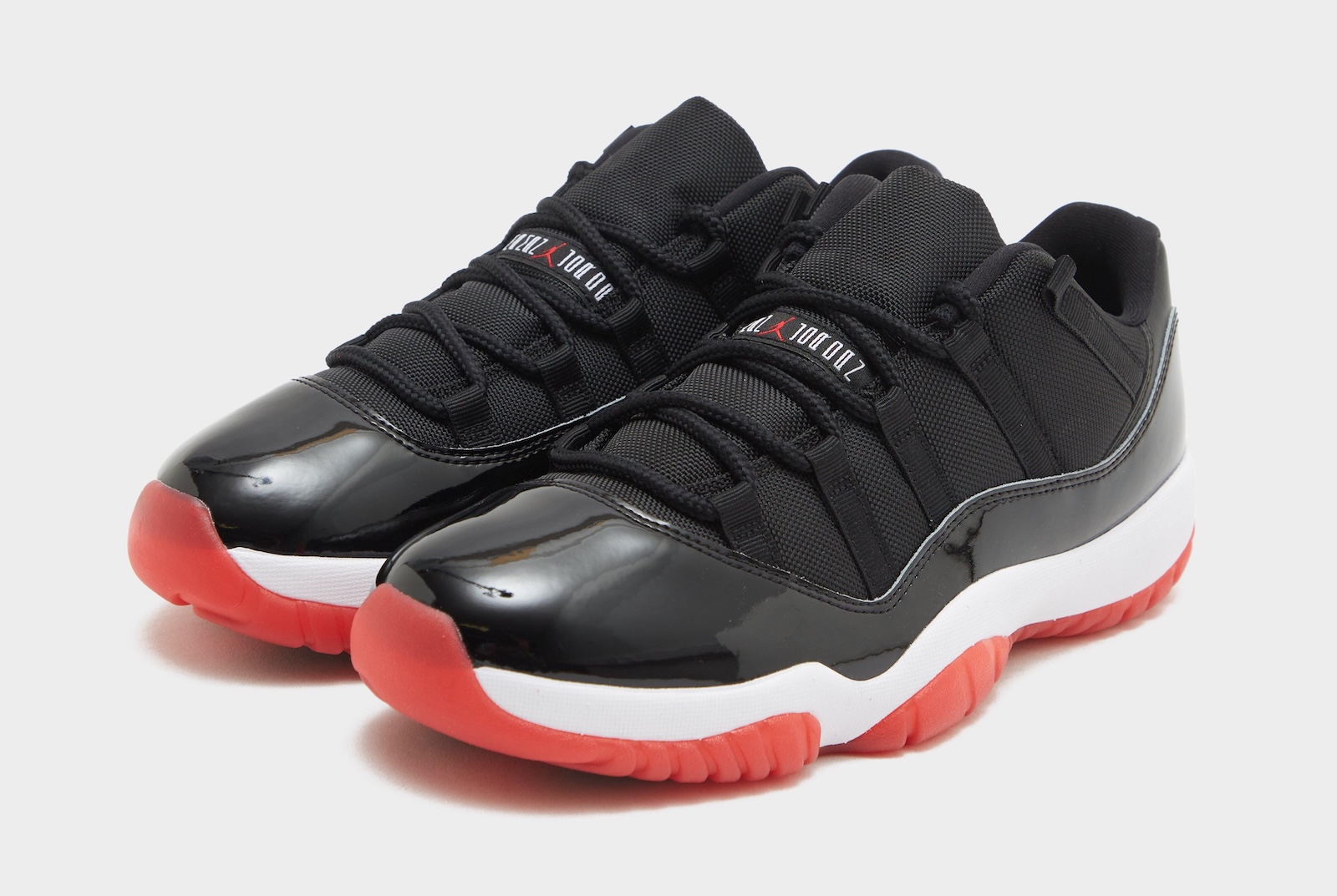 red black and white jordans 11 low top
